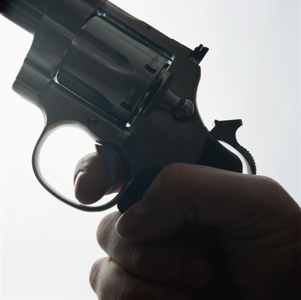 Hand holding gun, close-up