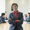 Black businesswoman in conference room with co-workers