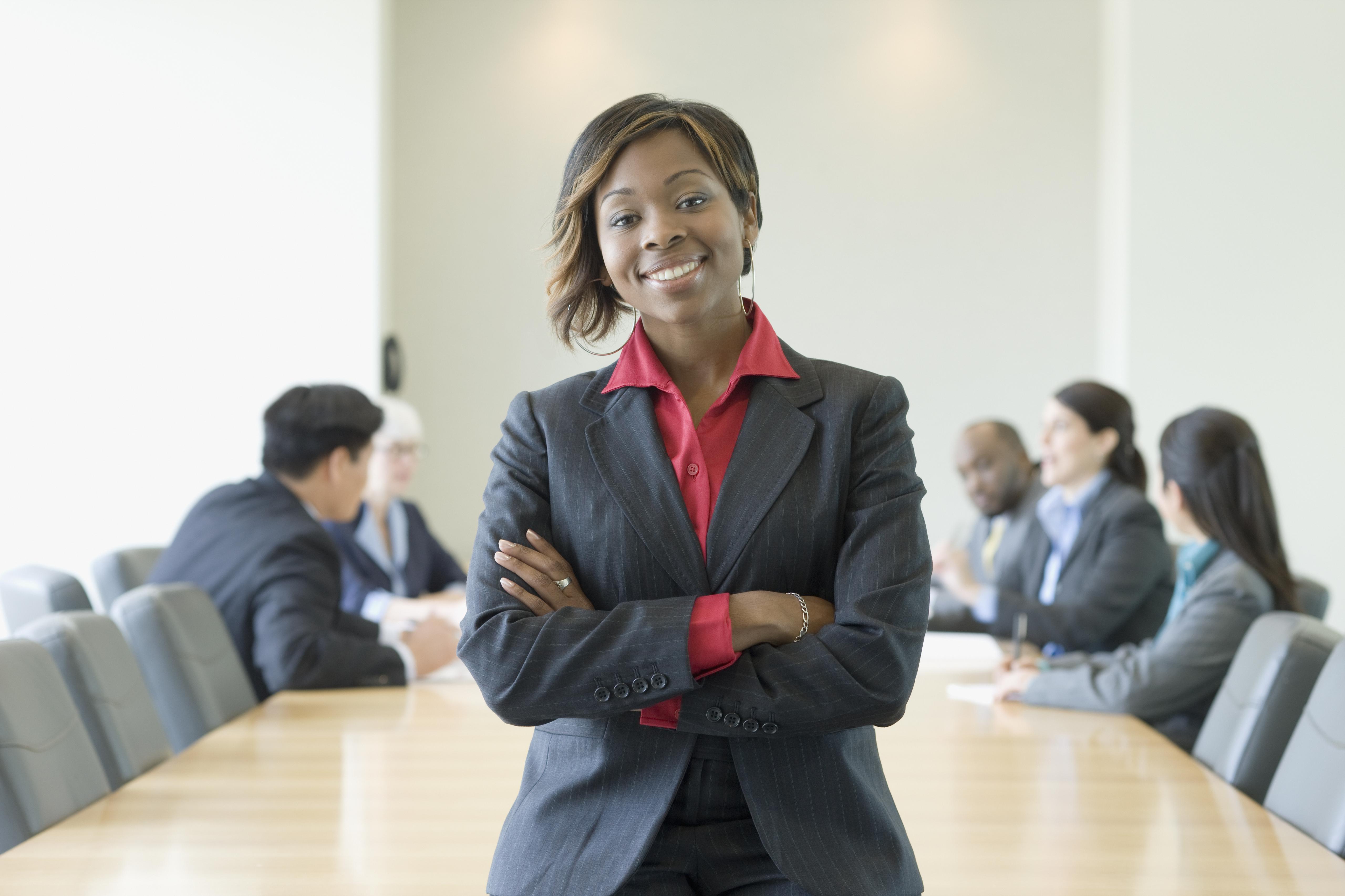Black businesswoman in conference room with co-workers