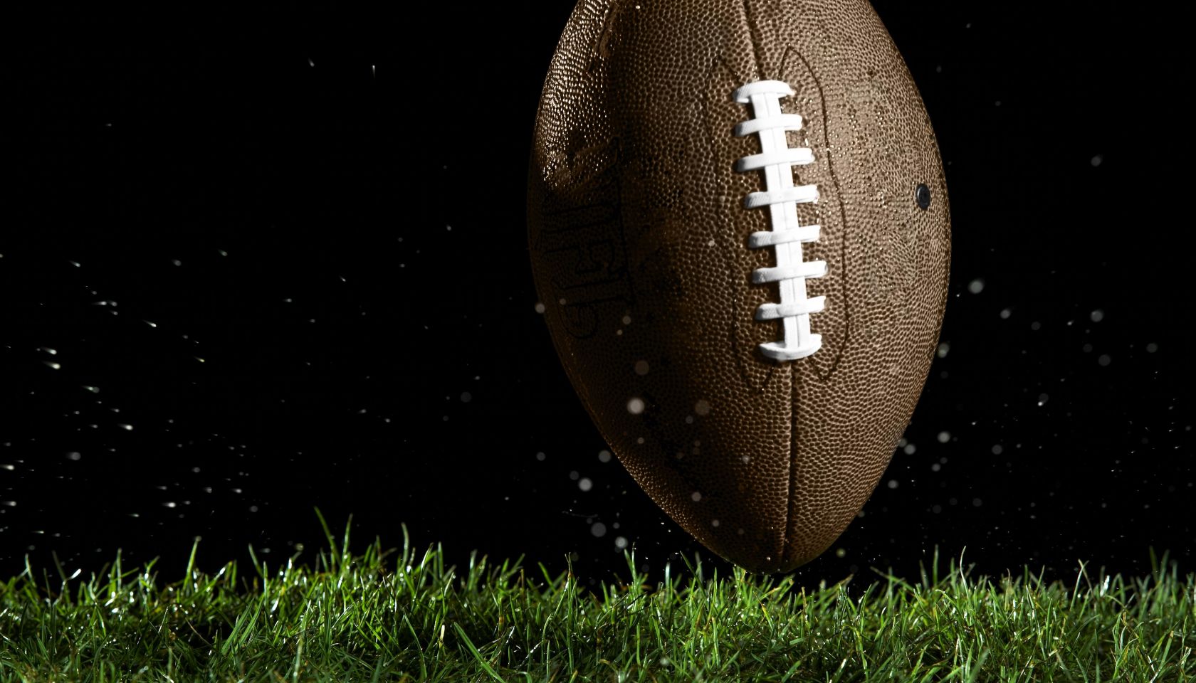 Football in motion over grass