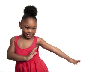 Beautiful little girl wearing red dress dances