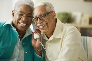 Elderly couple talking on the phone
