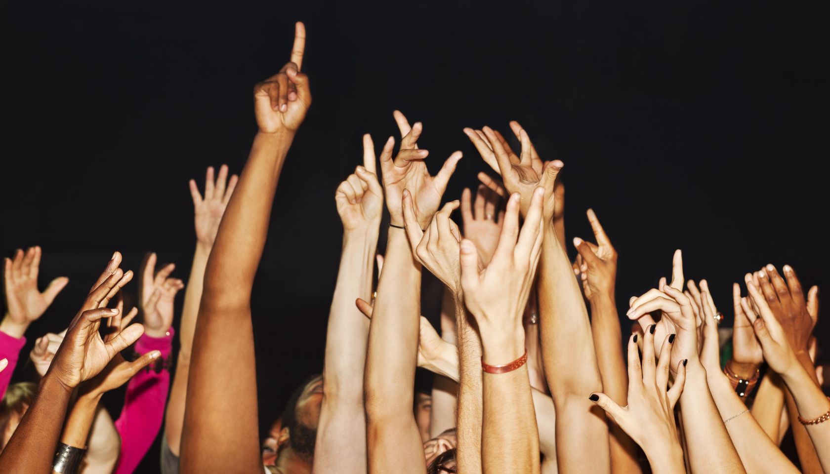 Large crowd with hands up