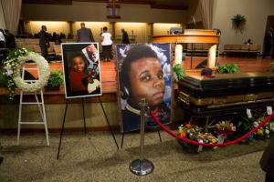 ST. LOUIS, MO - AUGUST 25:  Photos surround the casket of Michael Brown inside Friendly Temple Missionary Baptist Church awaiting the start of his funeral on August 25, 2014 in St. Louis Missouri. Michael Brown,18 year-old unarmed teenager, was shot and killed by a  Ferguson Police Officer Darren Wilson in the nearby town of Ferguson, Missouri on August 9. His death caused several days of violent protests along with rioting and looting in Ferguson.  (Photo by Richard Perry-Pool/Getty Images)