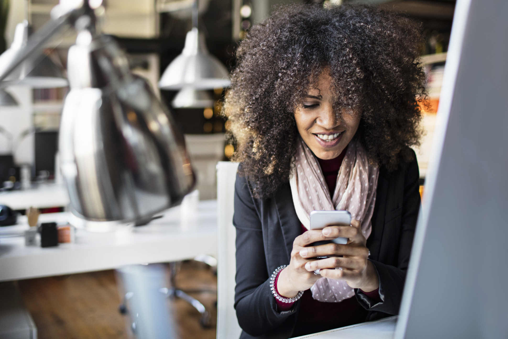 Young businesswomen texting on smartphone in the office