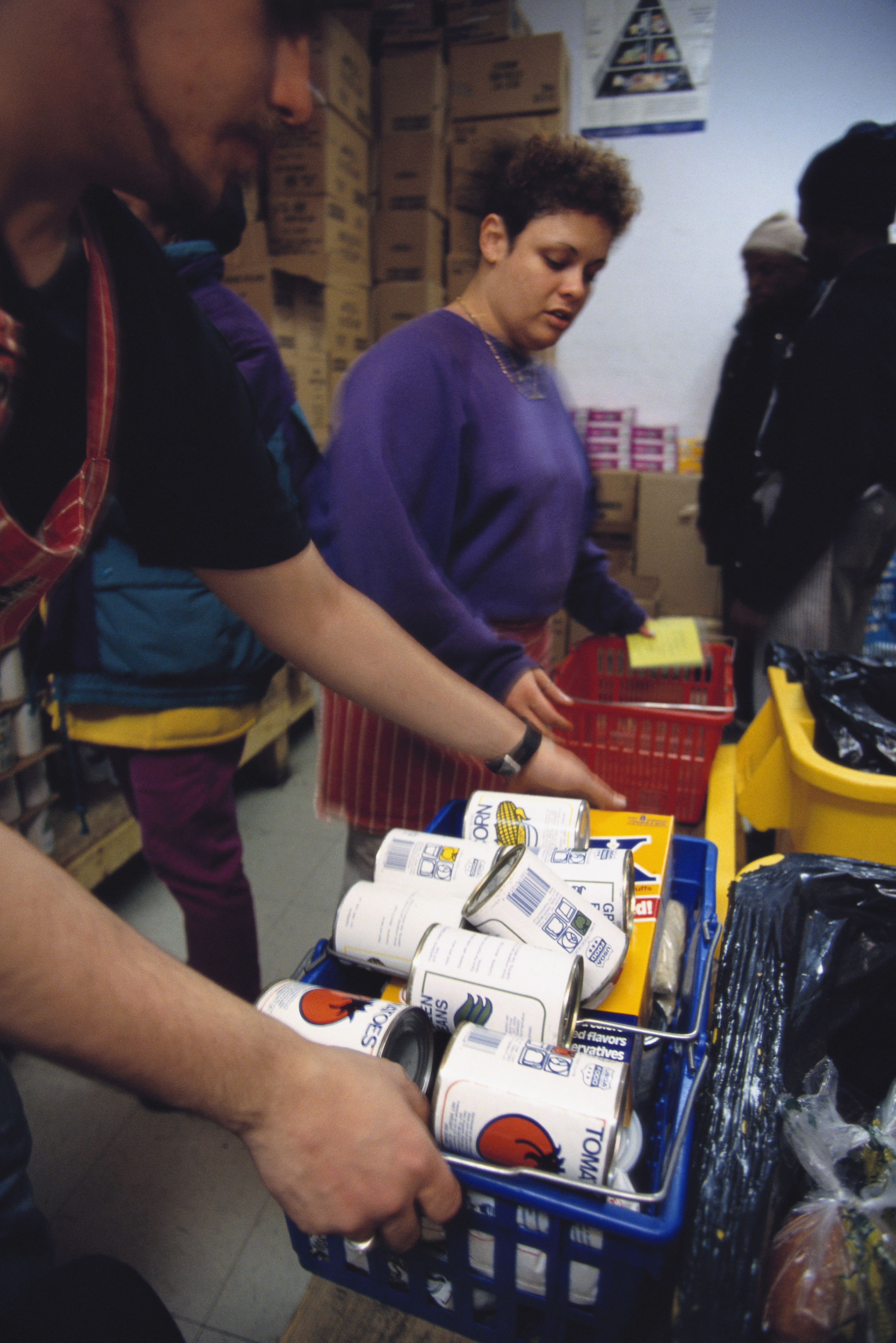 Volunteers Distribute Baskets of Food at a Food Pantry