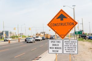 Construction ahead sign next to construction zone with...