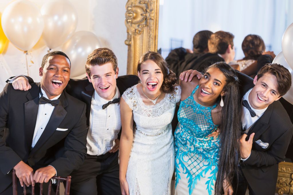 Teenagers and young adults in formalwear at party