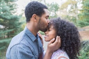 Young couple embraces and kisses outside
