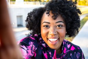 Curvy young black woman exercising, having sport training in the city public park