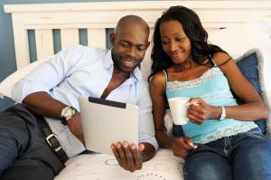 Modern African Couple Looking at Digital Tablet