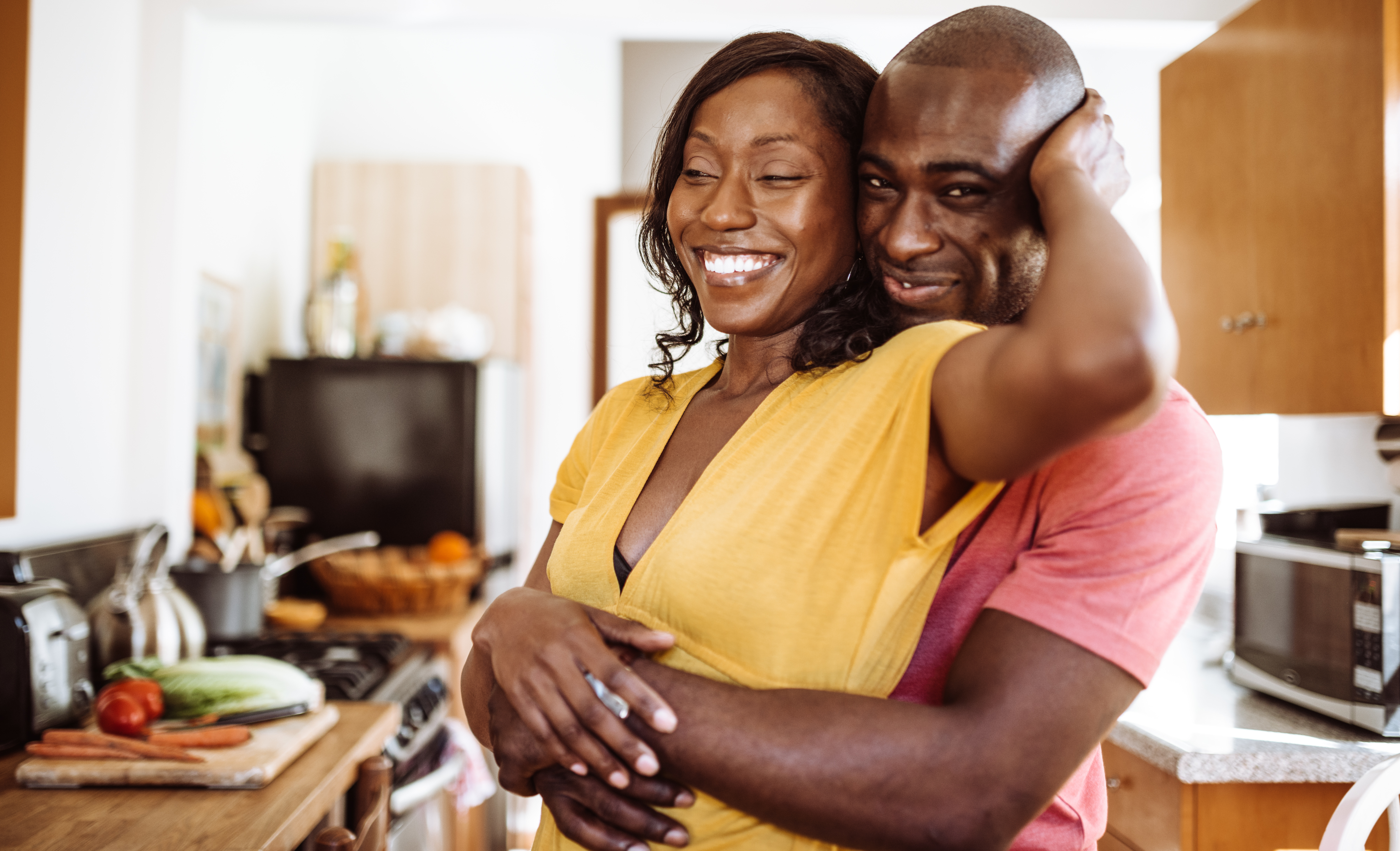 couple embracing in the kitchen