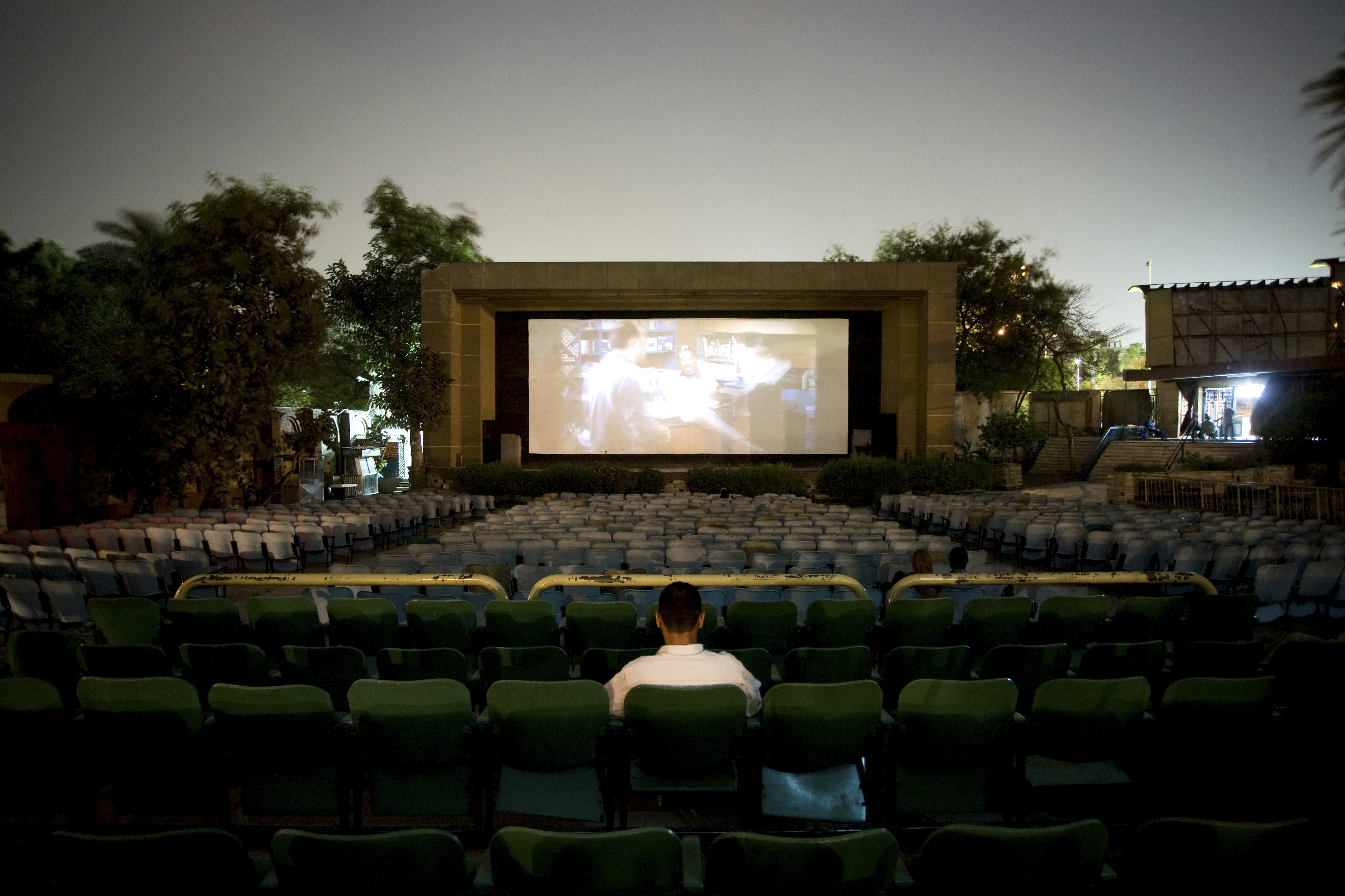 Only one customer can be found in the outdoor cinema El Rubos, Giza whilst watching the recent action film Kaos. Cinema audiences are still strong in Egypt but many prefer to use the new cinema multiplexes or larger indoor cinemas