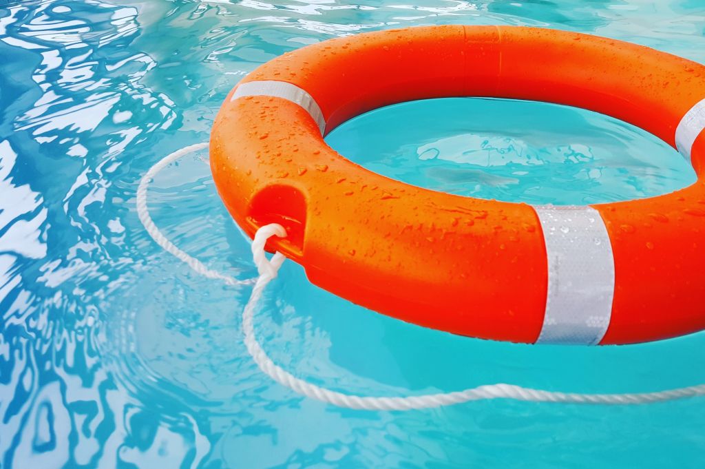 Close-Up Of Life Belt Floating On Swimming Pool