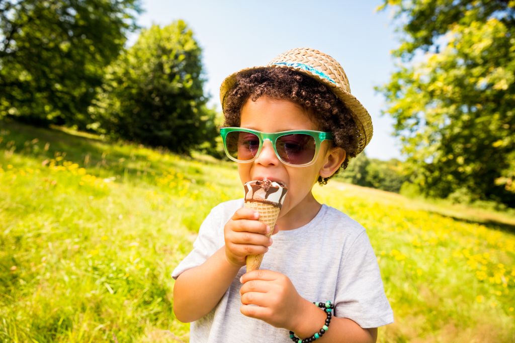 Little boy licking ice cream in a cone
