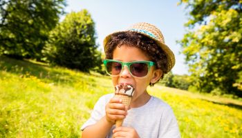 Little boy licking ice cream in a cone