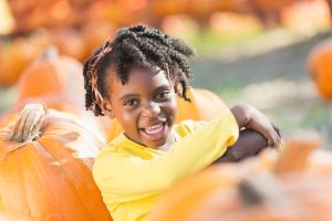 Little African-American girl in a pumpkin patch
