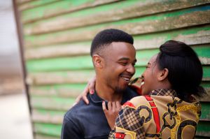 African couple looking into one another's eyes in a slum area