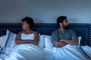 Man and woman sitting in bed