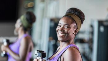 Young African-American woman working out at the gym