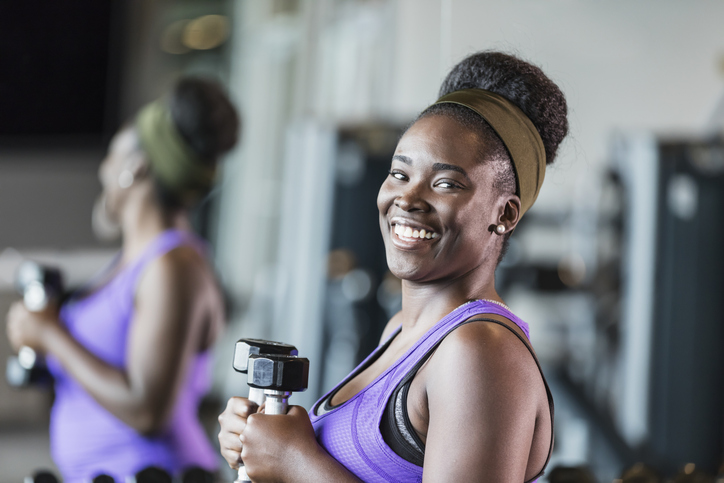 Young African-American woman working out at the gym