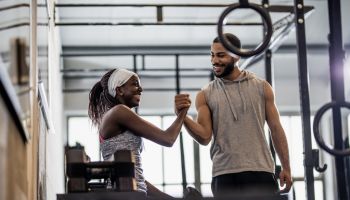 Woman Training Weight Lifting With an Instructor
