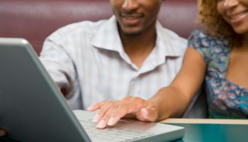 African American couple using laptop