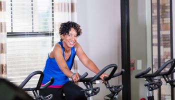 Mature African-American woman on exercise bike