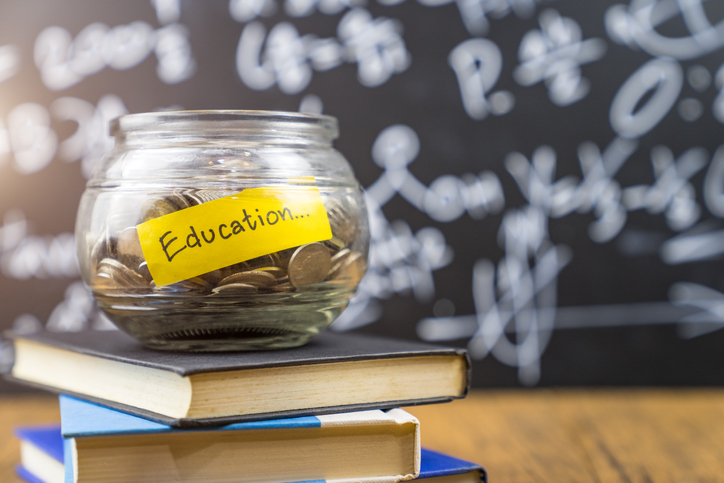 Many money coin in the glass jar with 'Education" wording