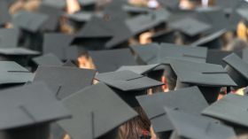 Students Wearing Mortarboards In City