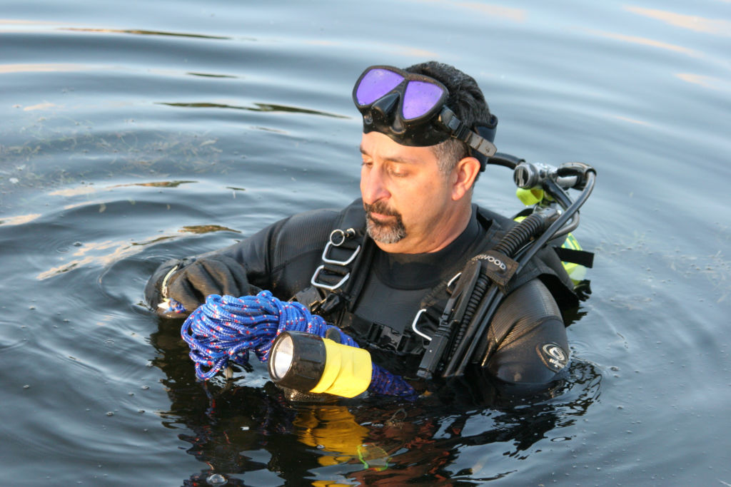 A policeman part of the police dive team in Snake Creek Canal.