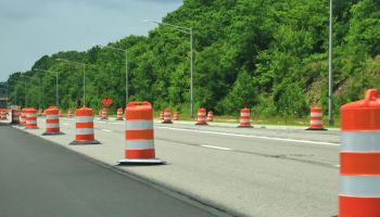 Orange construction barrels along the highway