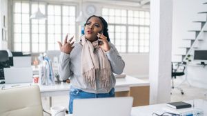 African businesswoman talking on phone in modern office