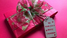 High Angle View Of Gift With Text Tag Over Pink Background