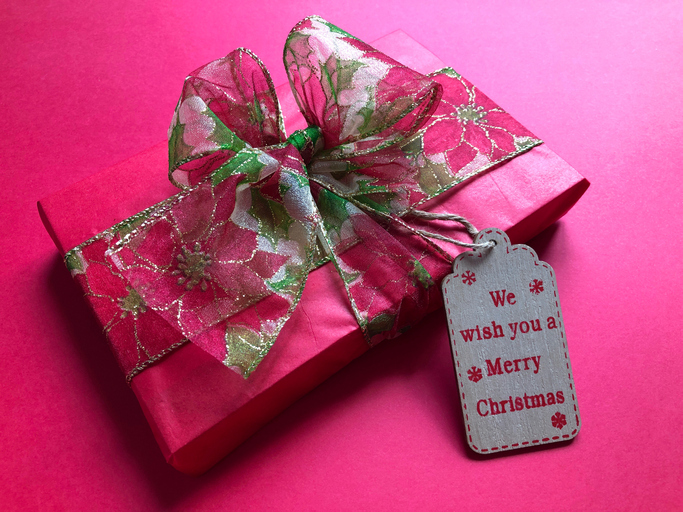 High Angle View Of Gift With Text Tag Over Pink Background