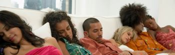 People sleep on couch at party