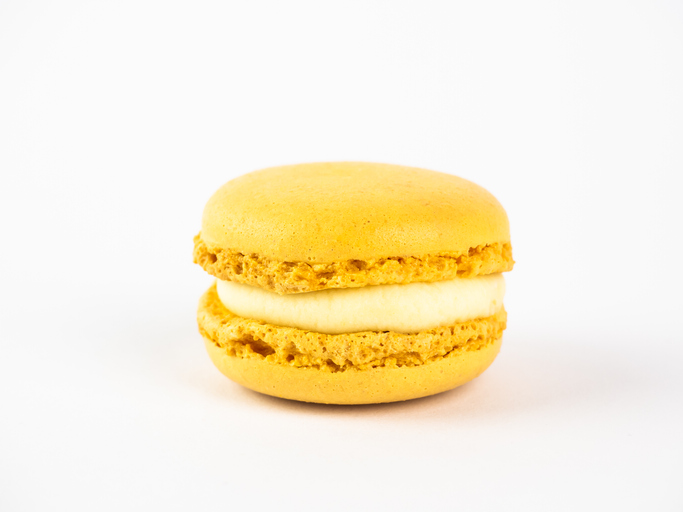 Lemon macaron against white background