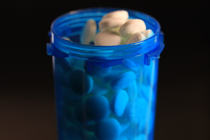 Open bottle of medical health supplements