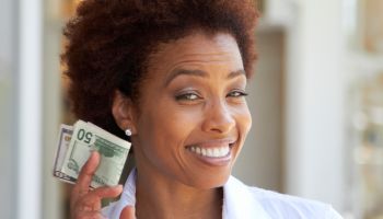 African American woman holding 50 dollar bill