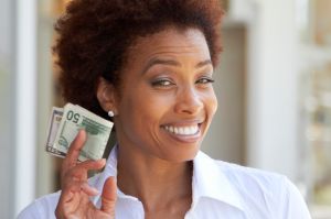 African American woman holding 50 dollar bill