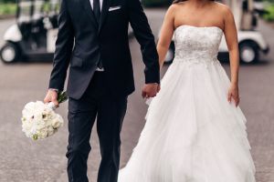 Midsection Of Newlywed Couple Standing On Street