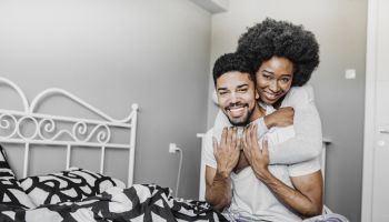 Loving young African American couple in bed