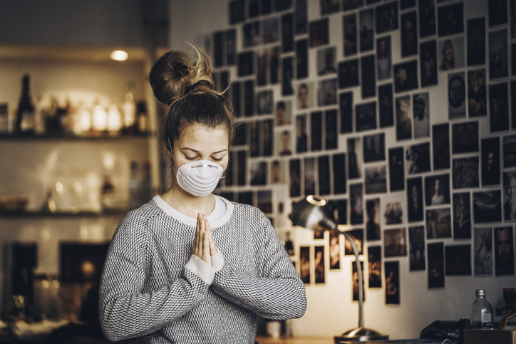 Young girl bows in meditation