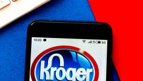 In this photo illustration a Kroger logo seen displayed on a...