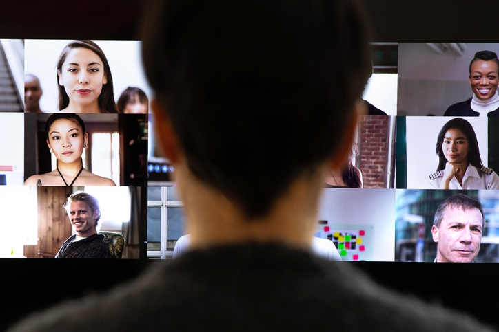 Woman in front of a device screen in video conference for work