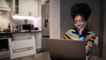 African ethnicity woman working from home