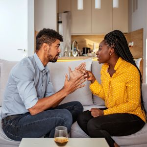 Black woman and man quarrelling at home