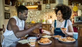 Afro American couple having breakfast in their home