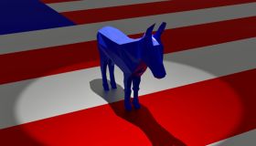 Democratic Blue Donkey in Spotlight on Top of American Flag