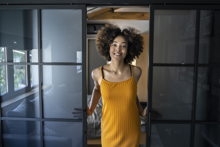 Smiling afro American young woman in modern home
